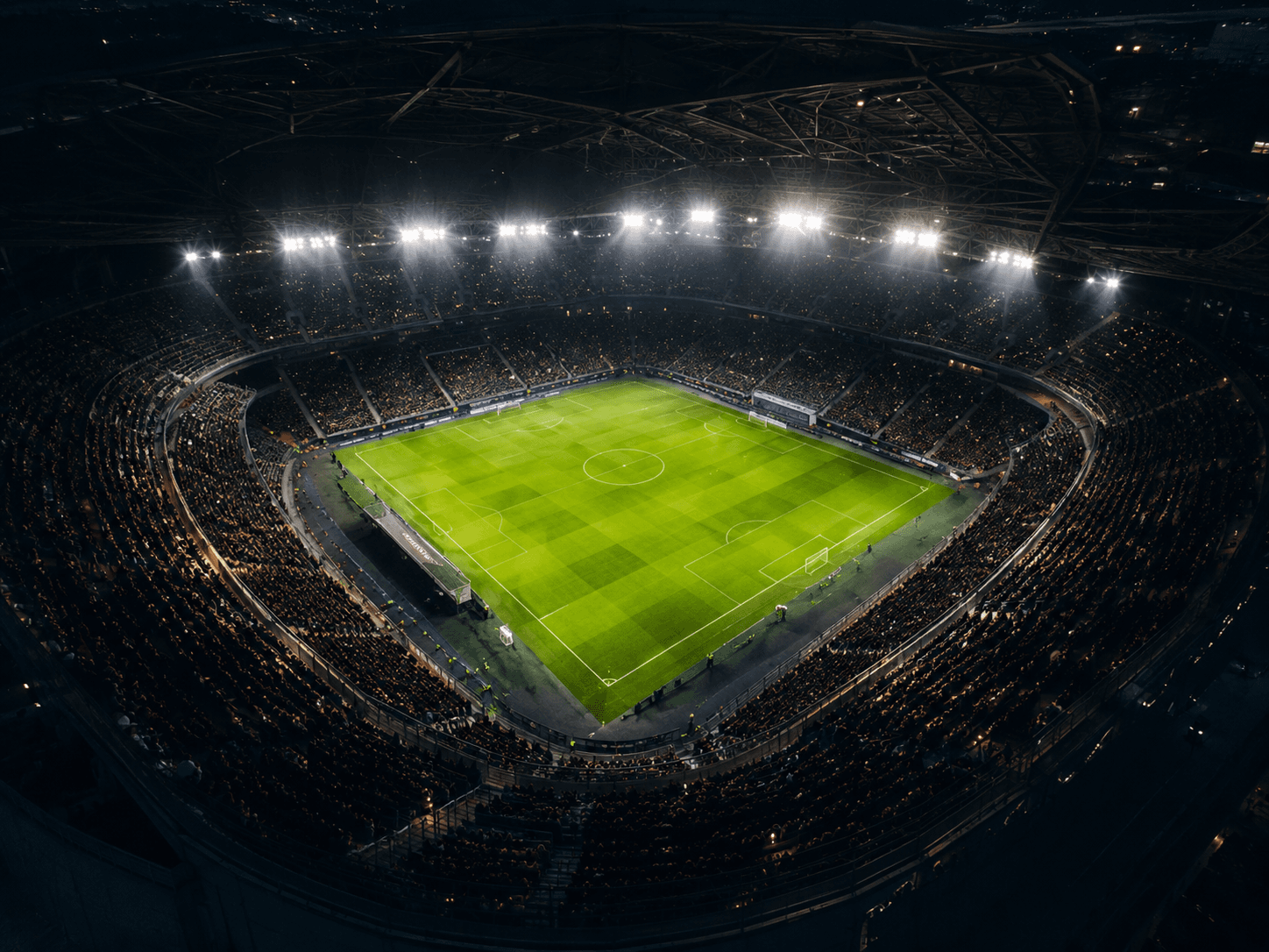 Aerial football stadium under floodlights